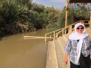 standing on the Jordan side of the Jordan River (Israel is just on the other side!)